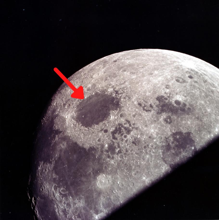 A photo of the Lunar Crisium Basin. A red arrow points to the basin, which looks like a lark dark spot on the Moon.