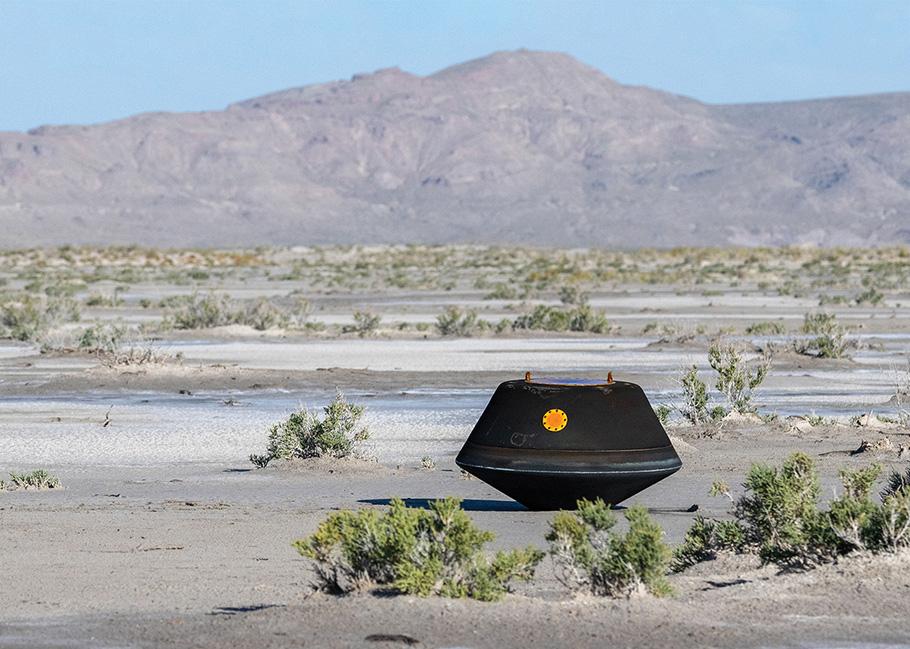 The OSIRIS-REx capsule sits alone in the bleak Utah desert, resembling a small black flying saucer that has just landed on Earth.