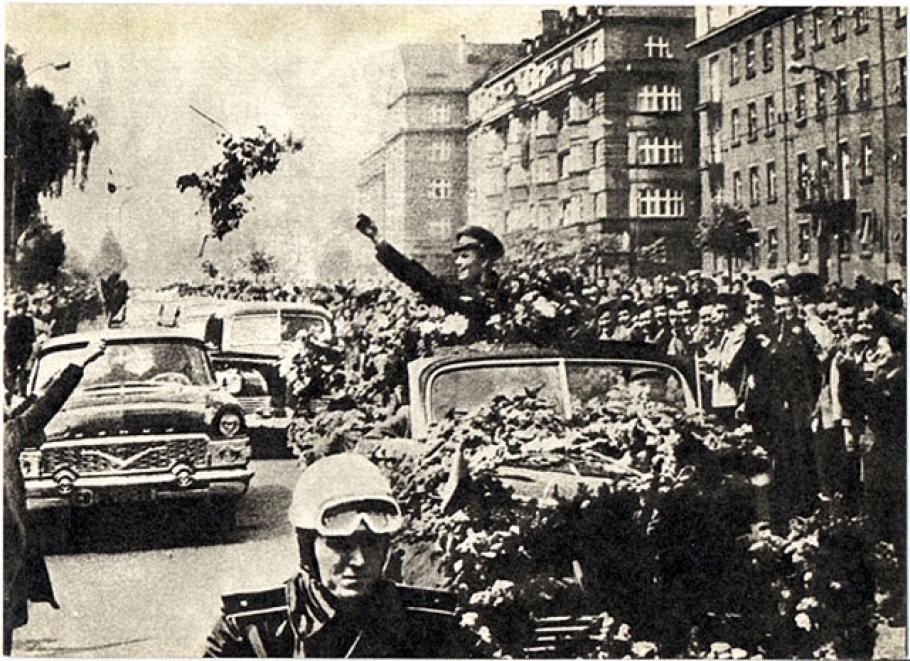 Gagarin waves to crowds en route to Red Square.