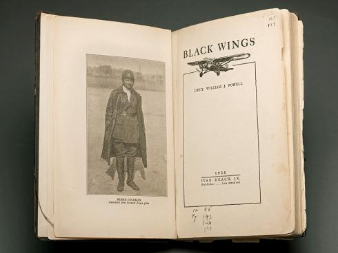 Open book spread of “Black Wings” with the page depicting aviator Bessie Coleman.