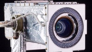 White metal rectangular box with camera lens on small side.