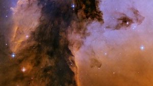 Purple, orange, and black dust spotted by stars.