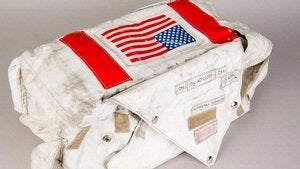 White bag with two red stripes stitched into the side around a United States flag.