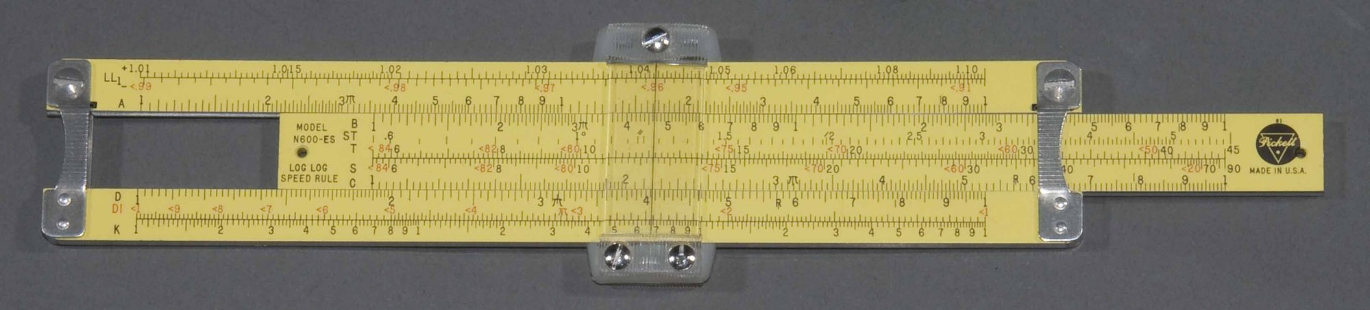 Yellow painted aluminum slide rule, with ruled markings on both sides, Plastic cursor.