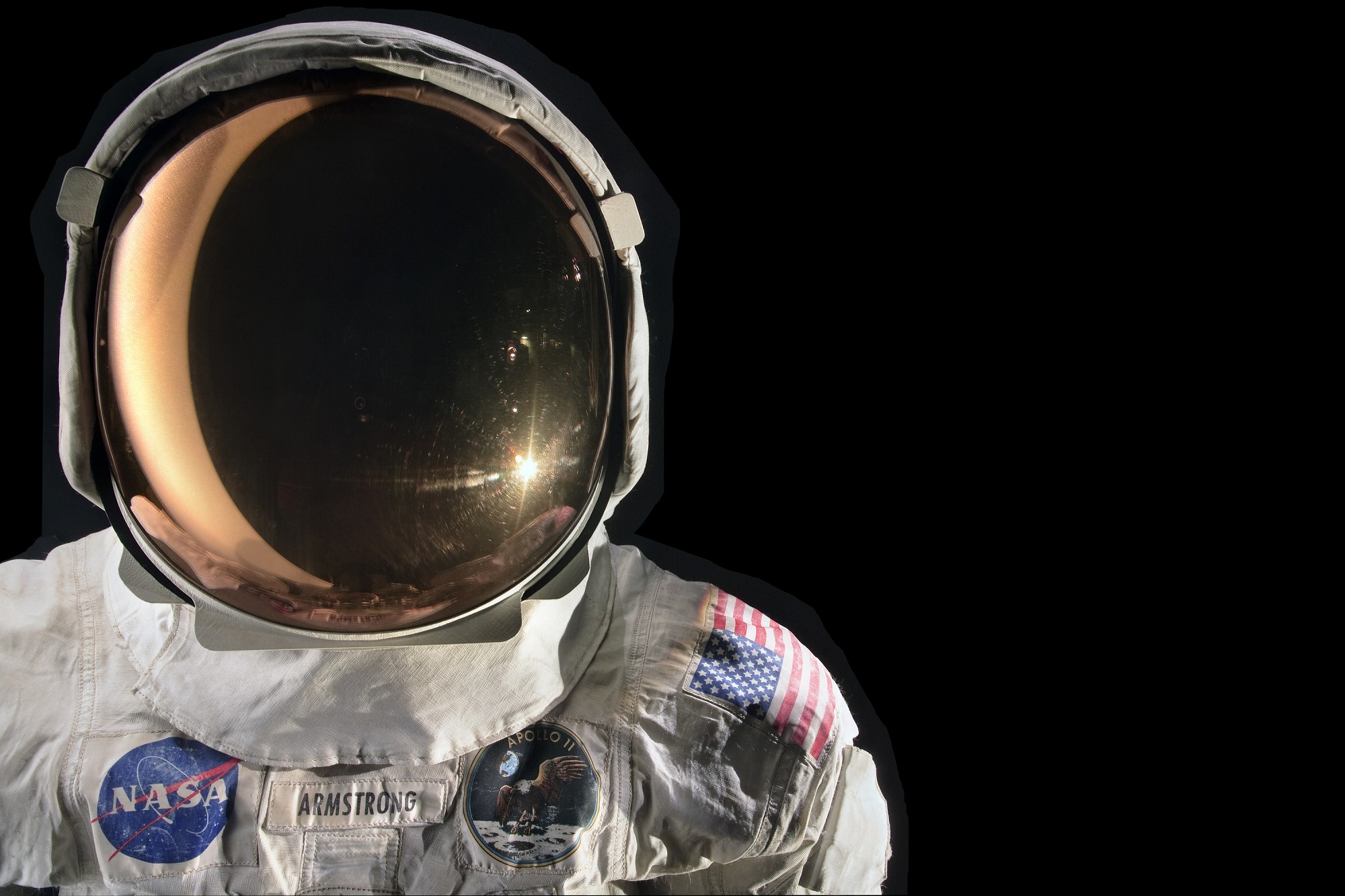 On the left side of the image, a crisp white spacesuit and helmet contrasts with the black background. 