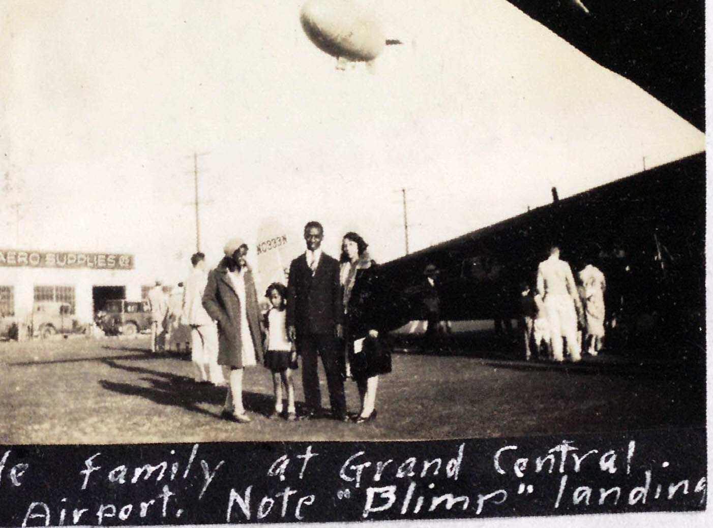 Family standing in front of airplane