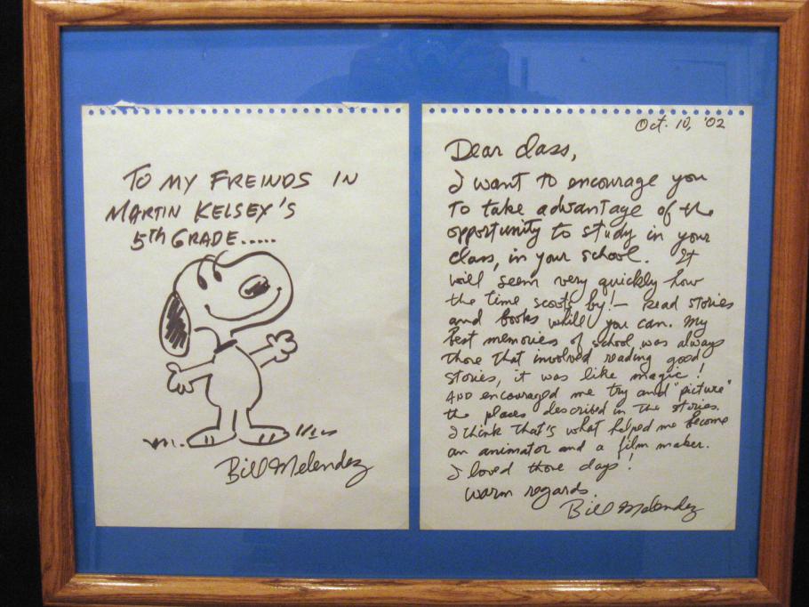 A framed letter with a drawing of Snoopy.