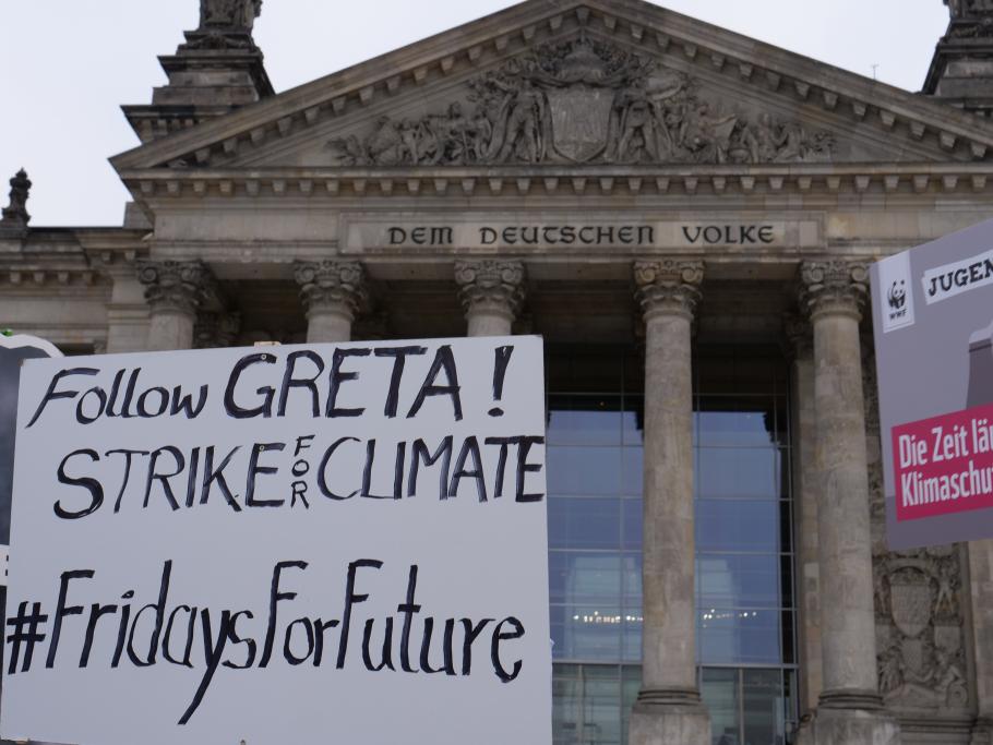 Sign that reads "Follow GReAT! STRIKE FOR CLIMATE #FridaysForFuture