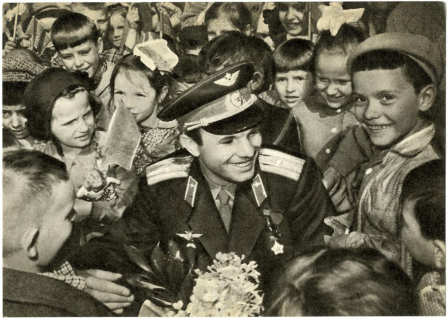 Soviet cosmonaut Yuri Gagarin surrounded by a crowd of children