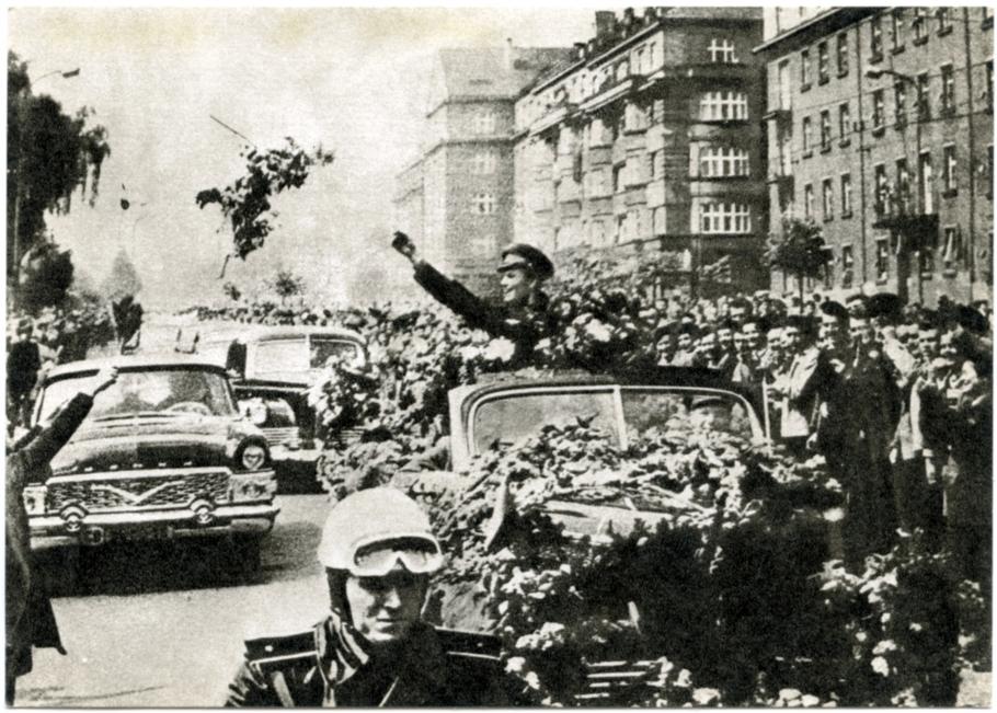 Soviet cosmonaut Yuri Gagarin waves to crowds at parade