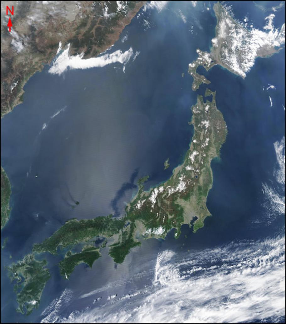 Satellite image of a large crescent shaped island nation on the continent of Asia.