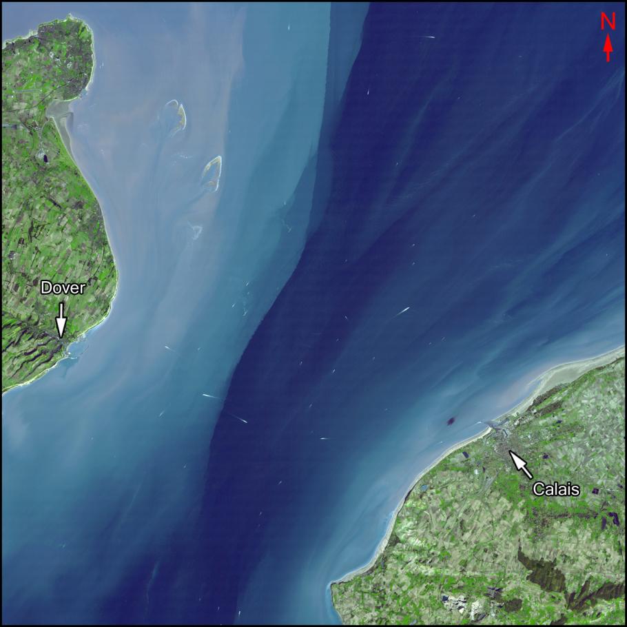 Satellite image of a channel of water with the city of Dover to the west, and the city of Calais to the east.