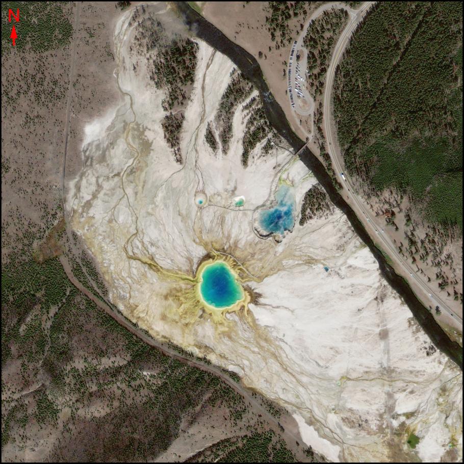 Satellite image of the Grand Prismatic Spring. The hot spring is vibrant with light and dark shades of color.