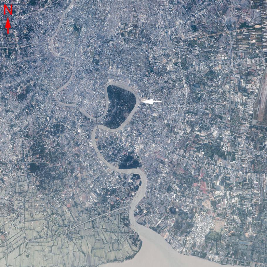 Satellite image of a dense city along a river.