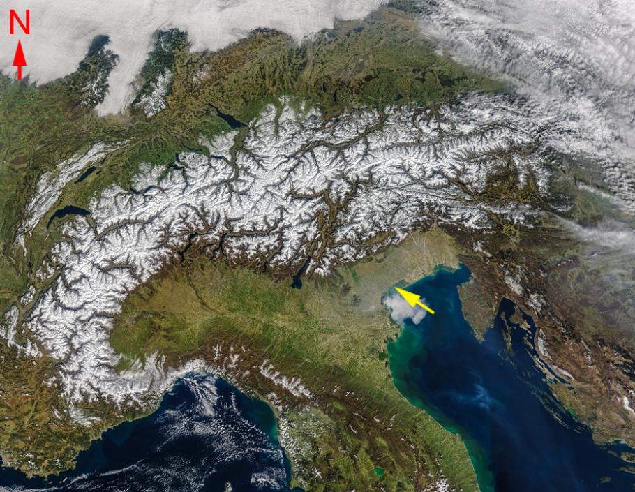 Satellite image of a snow-capped mountain range, with Italy to the south.