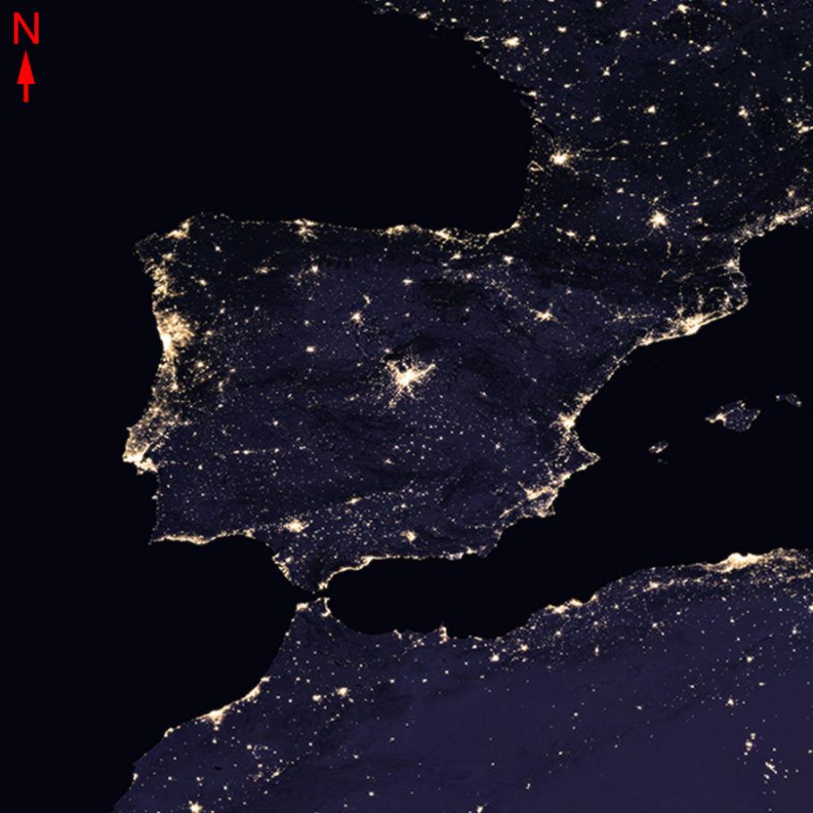 Challenge image of land mass at night with city lights across its surface.