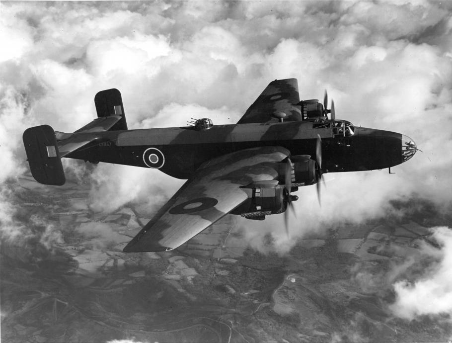 Handley Page Halifax in flight with clouds and the Earth in the background