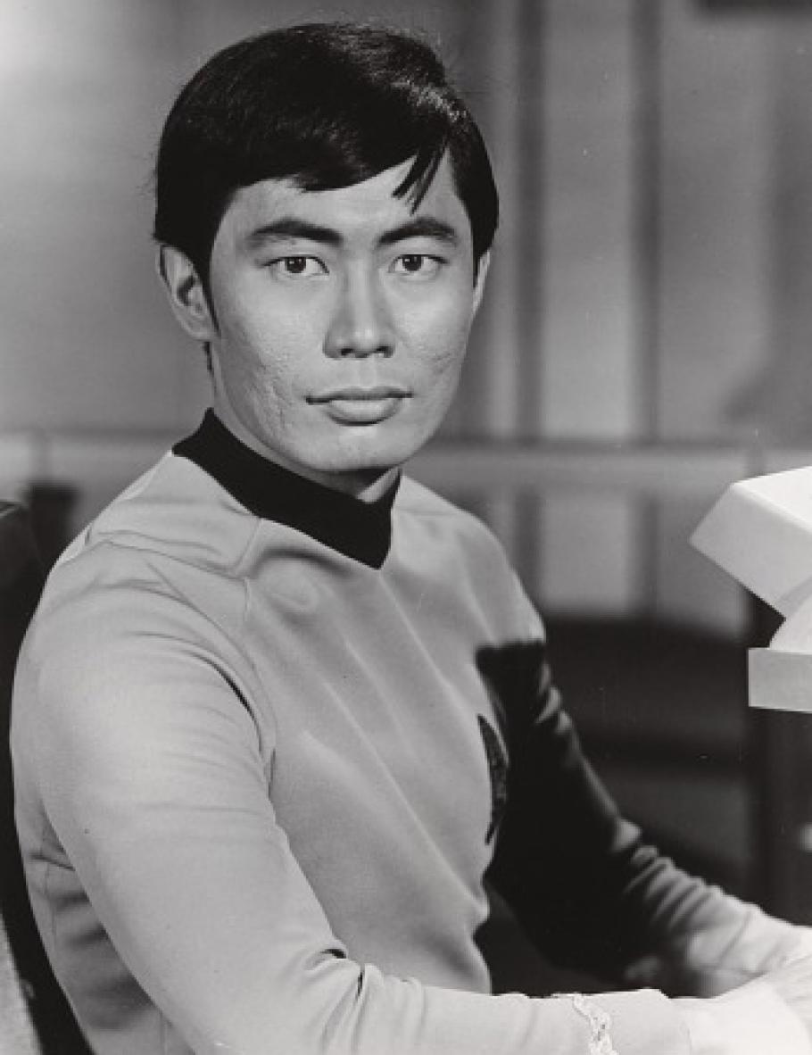 A man in a Star Trek uniform stares at the camera.