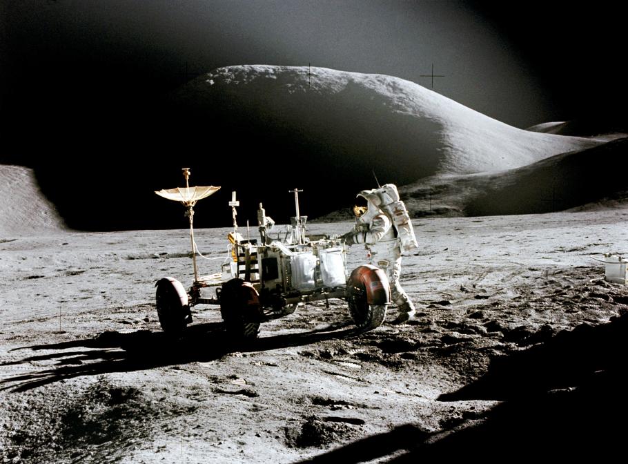 Jim Irwin works at the lunar roving vehicle (LRV) during the first Apollo 15 moonwalk. Picture captured by David Scott.