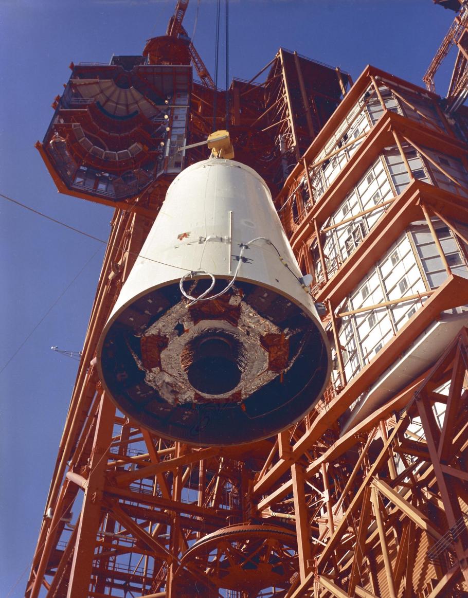 A color photograph of the Saturn Lunar Module (LM) Adapter being hoisted into position.
