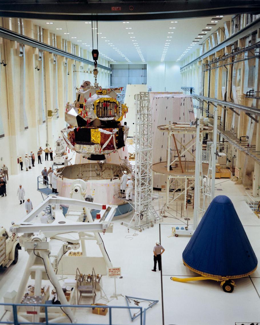 A color photograph of Lunar Module 1 being moved into position for mating with Spacecraft Lunar Module Adapter 7 in the Kennedy Space Center's Manned Spacecraft Operations Building.