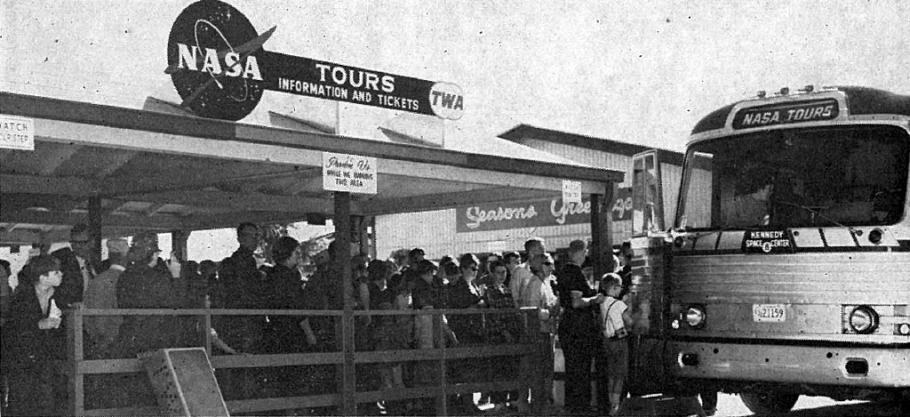 Black and white image of a crowd of people lined up with a bus arriving at the side of the shot. There is a NASA logo and a sign that says "Tours"