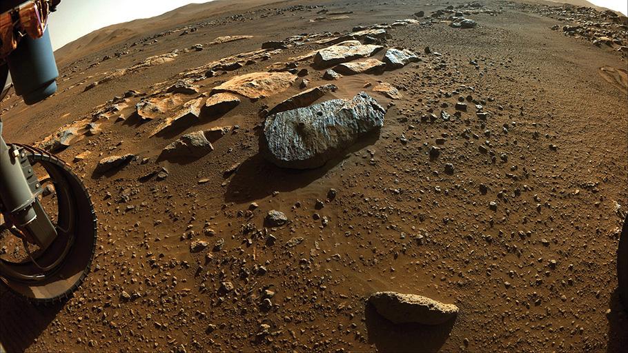 Photo of Mar's gravely surface with a rover wheel visible in the corner.