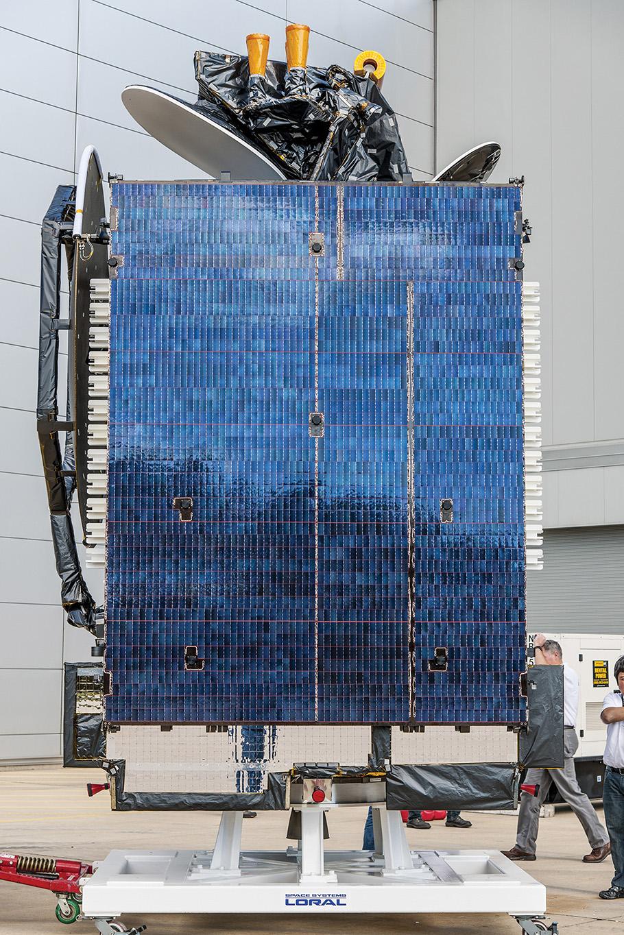 The satellite is shaped like a long rectangle, about three times as tall as an adult man and covered in glass tiles 