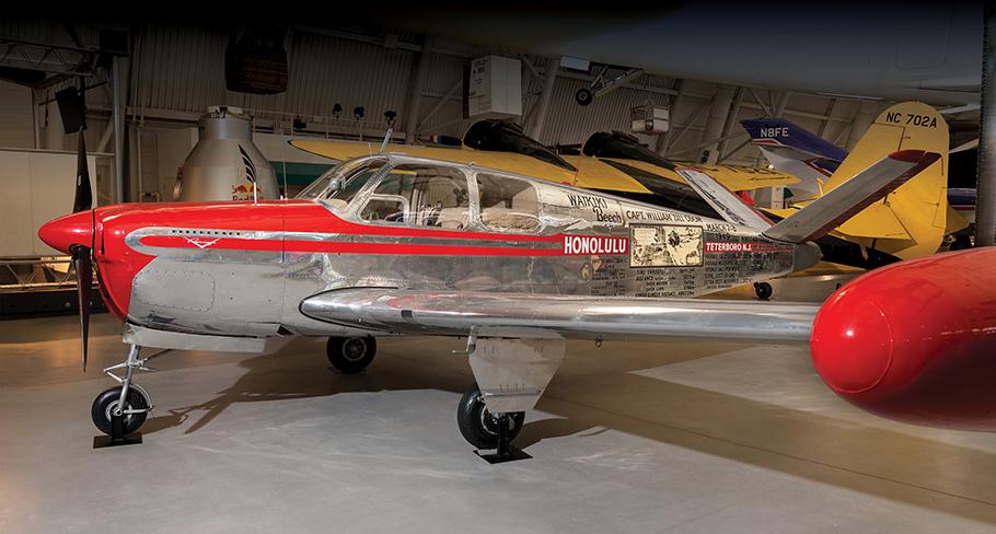Small chrome plane with writing and map of flight path painted on side.
