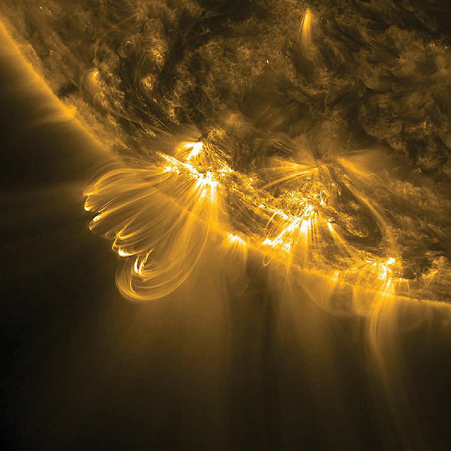 A close up picture of the sun with shining spirals erupting from the globe.