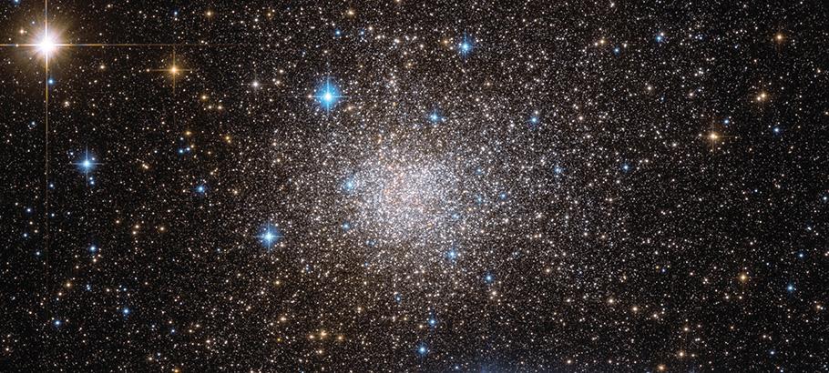 A cluster of stars growing brighter and more dense towards a central point. 