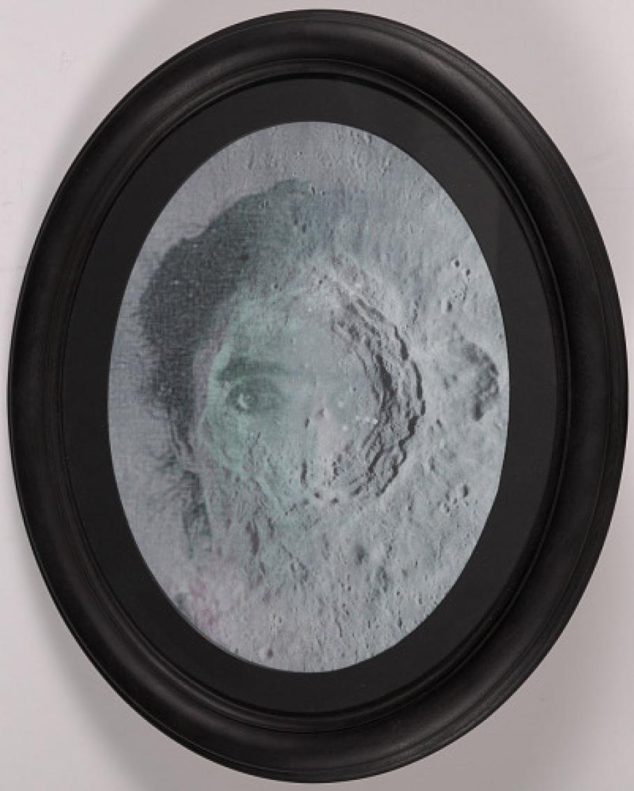 The Leavitt Crater art work that portrays the face of a woman superimposed on a lunar crater.