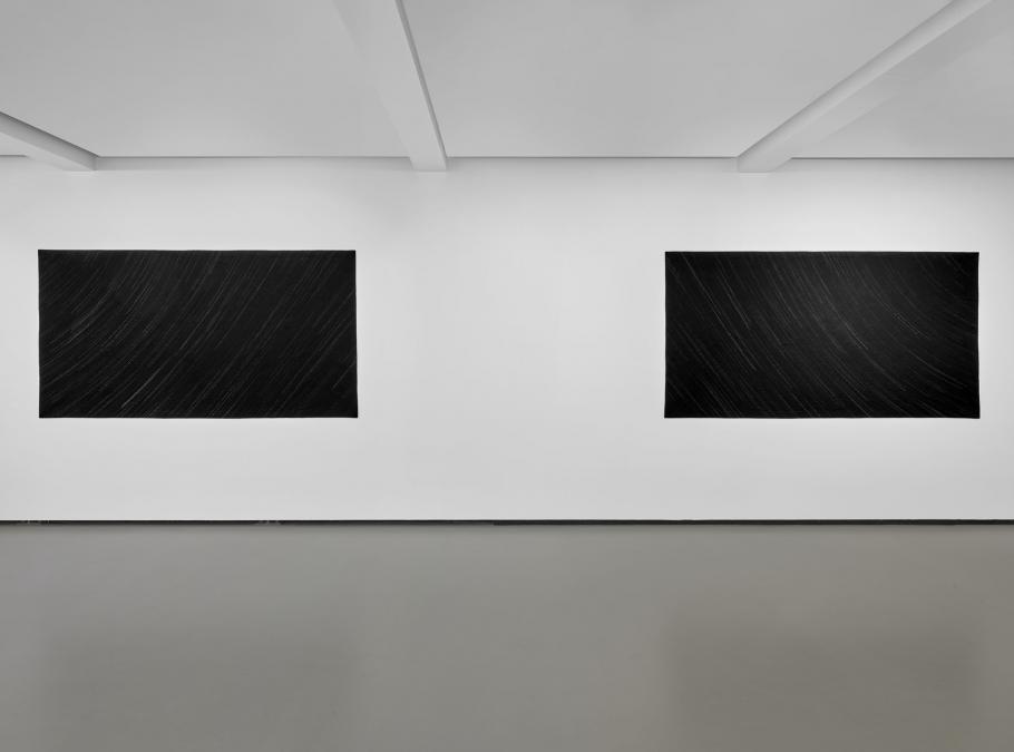 Two works of art with the same dimensions displayed on a white wall in a gallery.
