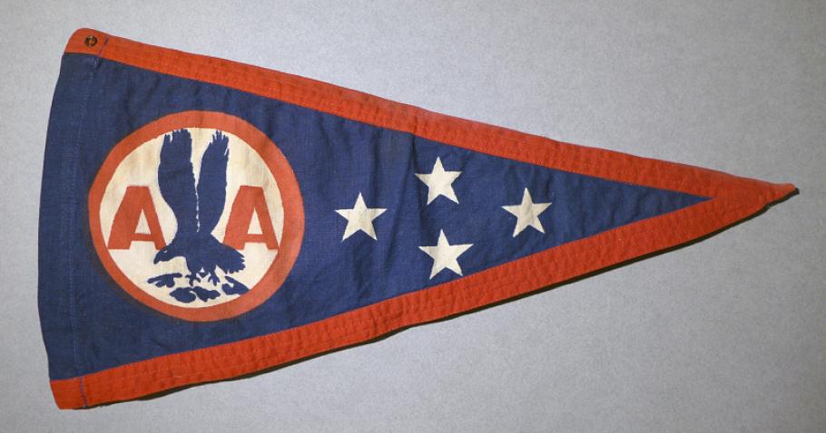A photo of a triangle-shaped red white and blue pennant featuring 4 stars and the American Airlines logo.