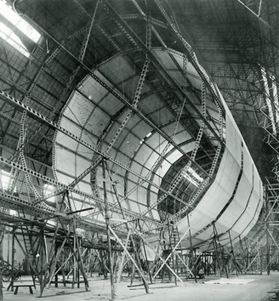 The framework of an airship. Half of the frame is covered in material.