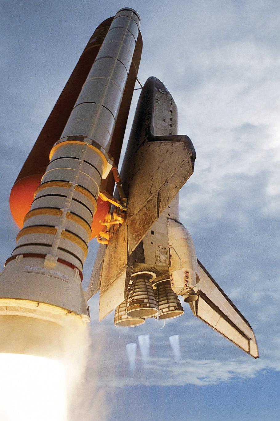 Space Shuttle Discovery and booster in mid launch