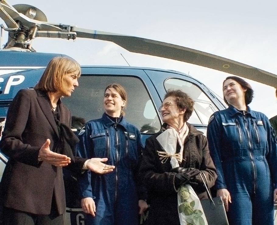 Group of four Frenchwomen in front of a helicopter