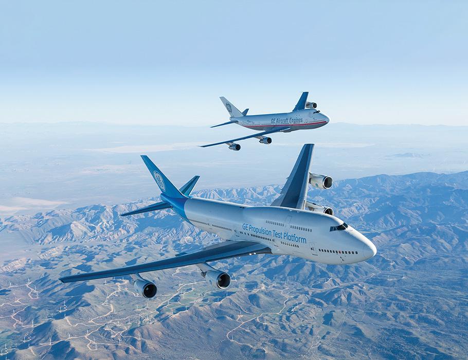 Two passenger airliners above a mountainous landscape
