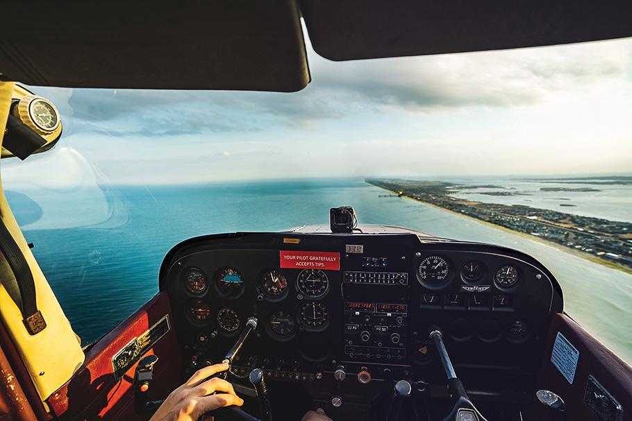 Pilot's view from Cessna Skyhawk cockpit over the coastline