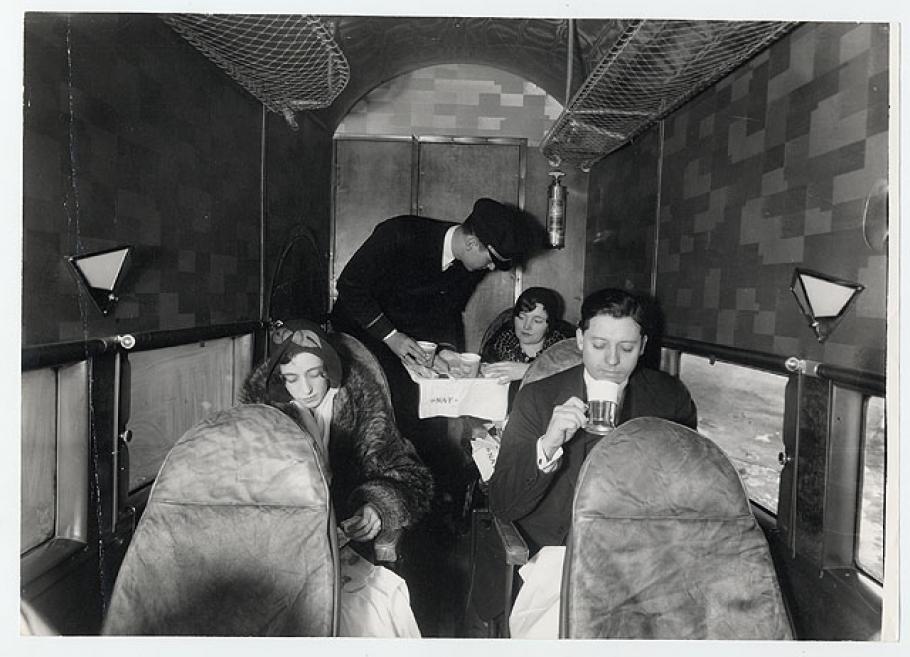 Steward serves drinks to passengers on board an aircraft 
