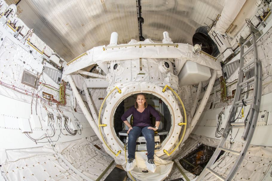 Curator sits inside an empty bay inside of Space Shuttle Discovery.
