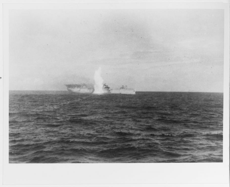 Black and white grainy image of the USS Langley under attack
