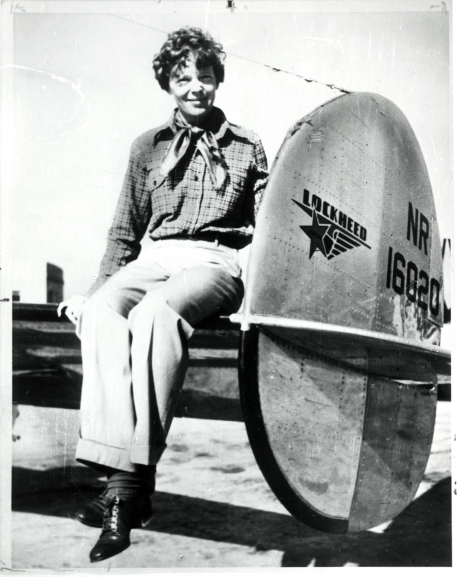 Amelia Earhart seated on the horizontal stabilizer of her Lockheed Model 10-E Electra