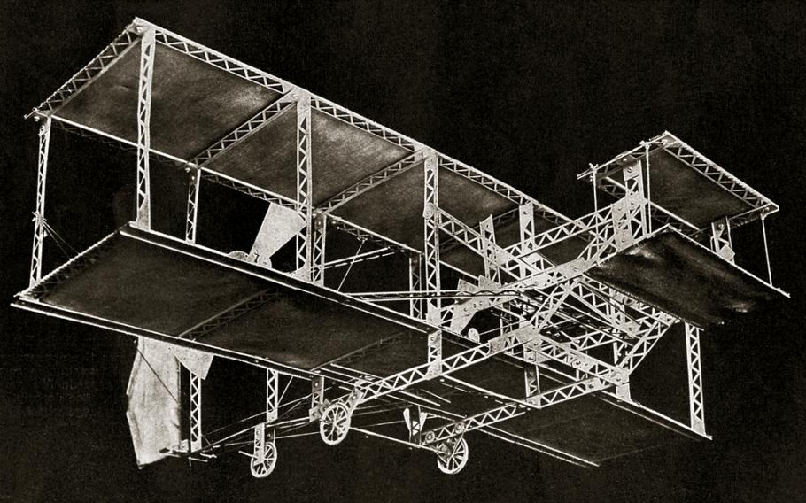 Model of a Wright-type biplane against a black background.