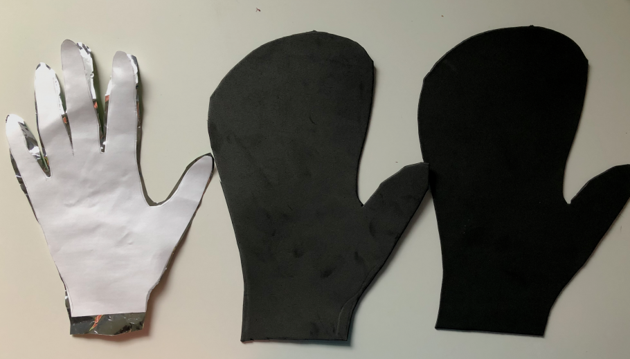 Two cut out of hands stacked on top of each other, next to two glove shaped cut outs.
