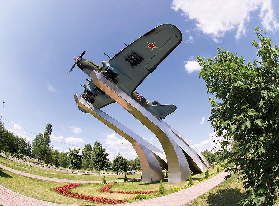 A Russian memorial consists of a restored IL-2 aircraft mounted on huge steel beams pointed toward the sky as if it is prepared to take off.