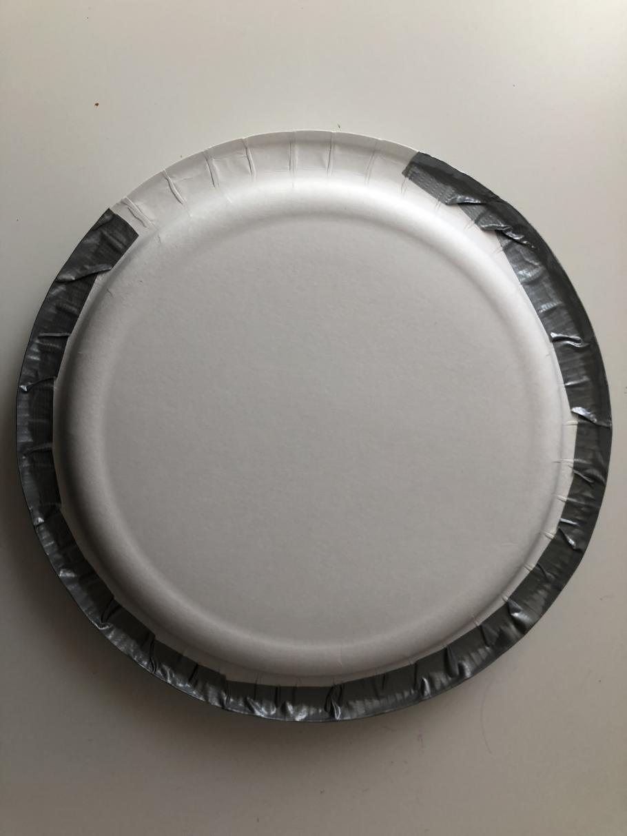 Two plates facing each other taped together with duct tape. 