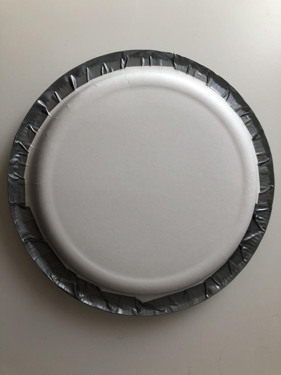 Two plates facing each other taped together with duct tape. 