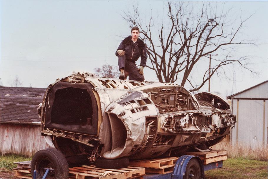 A young Al Casby sits atop a gutted mid-section of a Cutlass airframe.