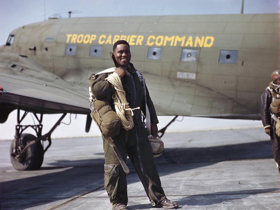 Lieutenant Clifford Allen of Chicago, Illinois, stands in front of a C-47 preparing to drop the 555th Parachute Infantry Battalion, the only African-American parachute unit.